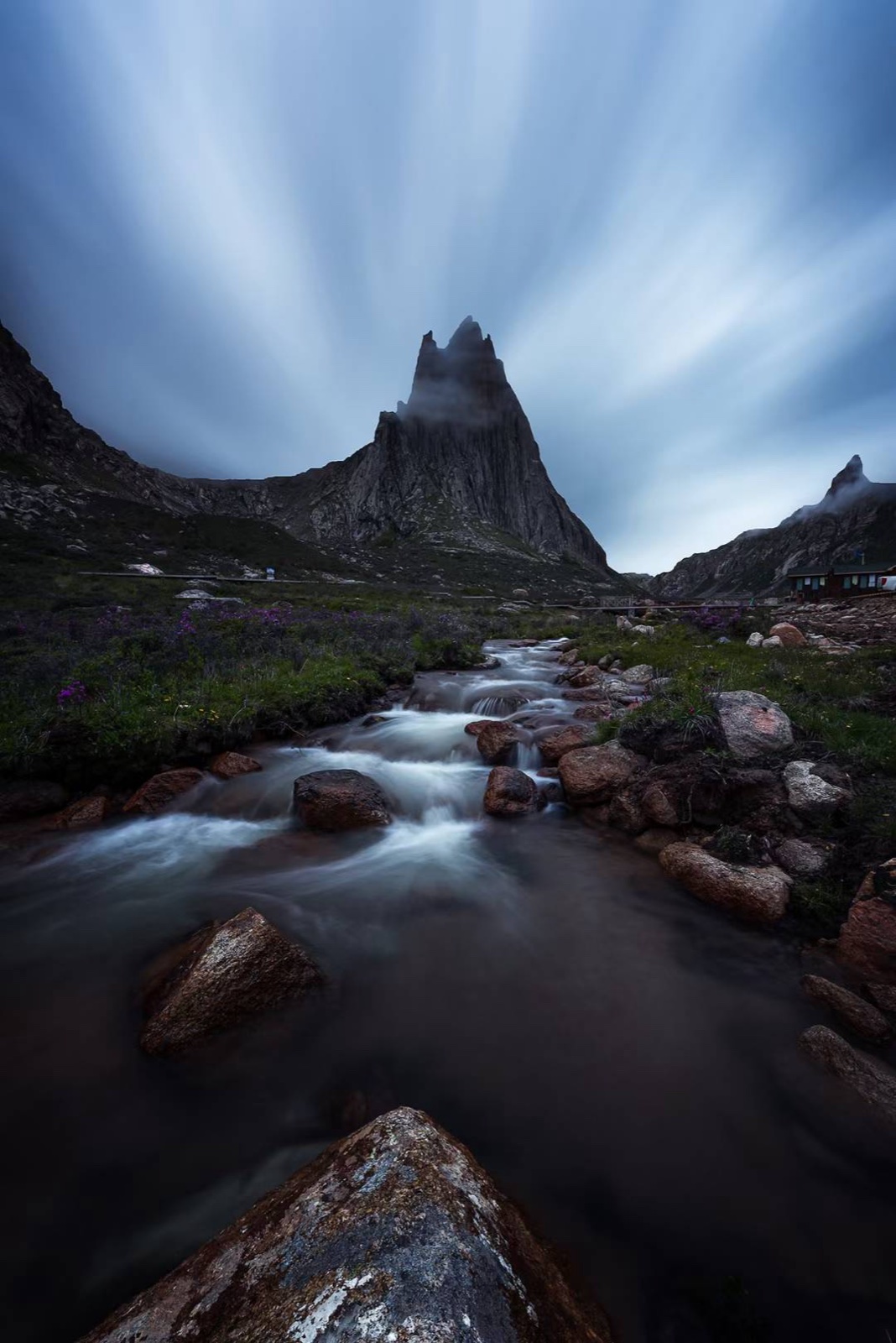 Long-exposure peak and stream at blue hour