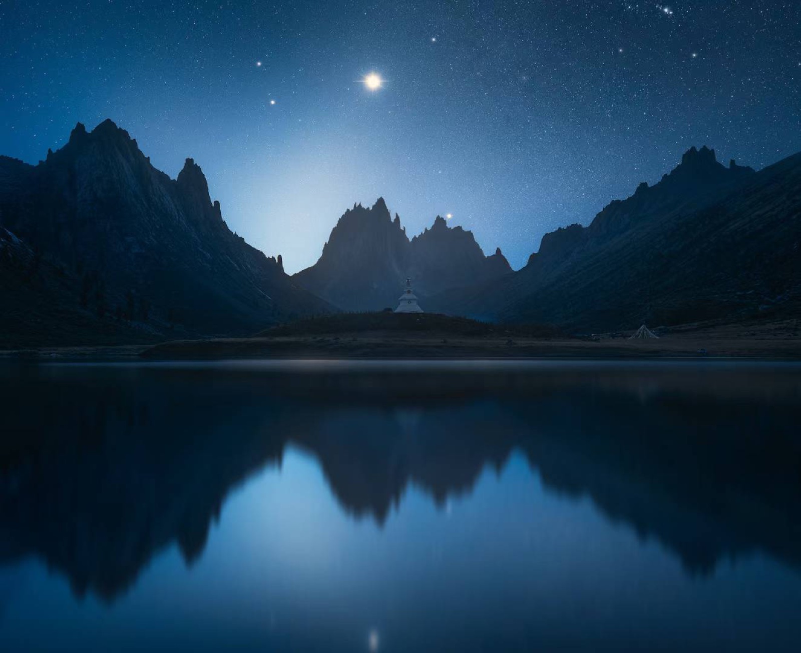 Moonlit alpine lake reflection